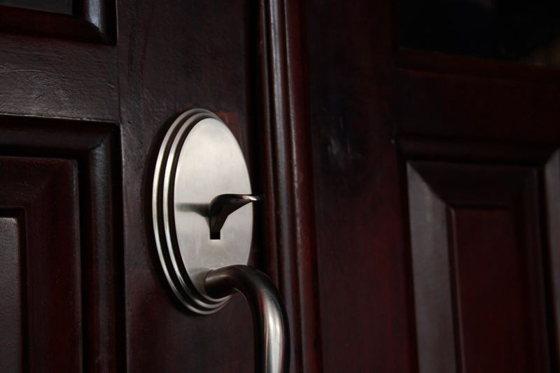 Deadbolt on a dark timber entry door
